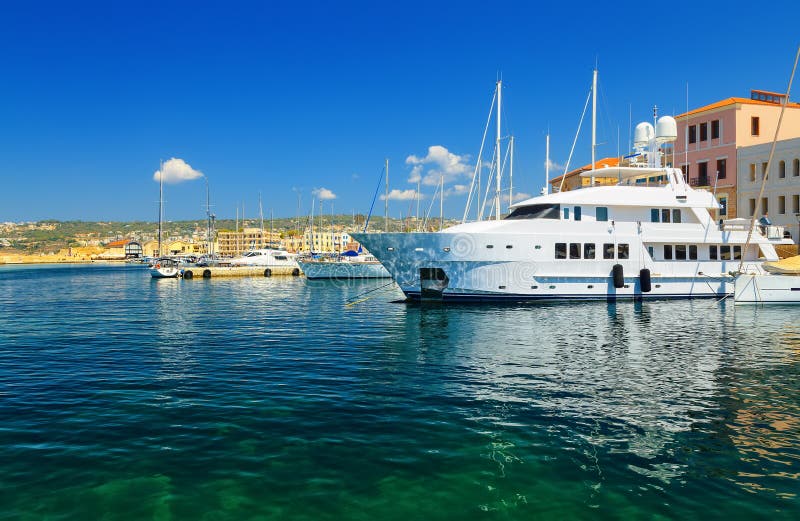 The large white luxurious yachts alongside dock at Mediterranean Sea, Chania, Crete, Greece royalty free stock photography The large white luxurious yachts alongside dock at Mediterranean Sea, Chania, Crete, Greece royalty free stock photography