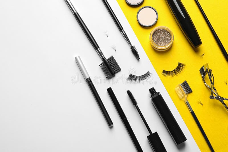 Flat lay composition with false eyelashes and other makeup products on color background, space for text. Flat lay composition with false eyelashes and other makeup products on color background, space for text