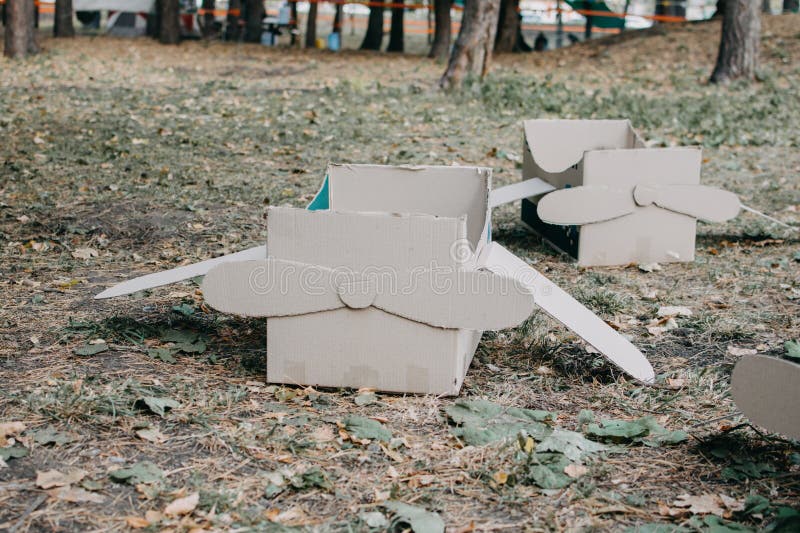 Upcycling ideas, Recycle crafts. Toy airplane made from cardboard boxes on grass. DIY Creative cardboard paper ideas for children. Upcycling ideas, Recycle crafts. Toy airplane made from cardboard boxes on grass. DIY Creative cardboard paper ideas for children.