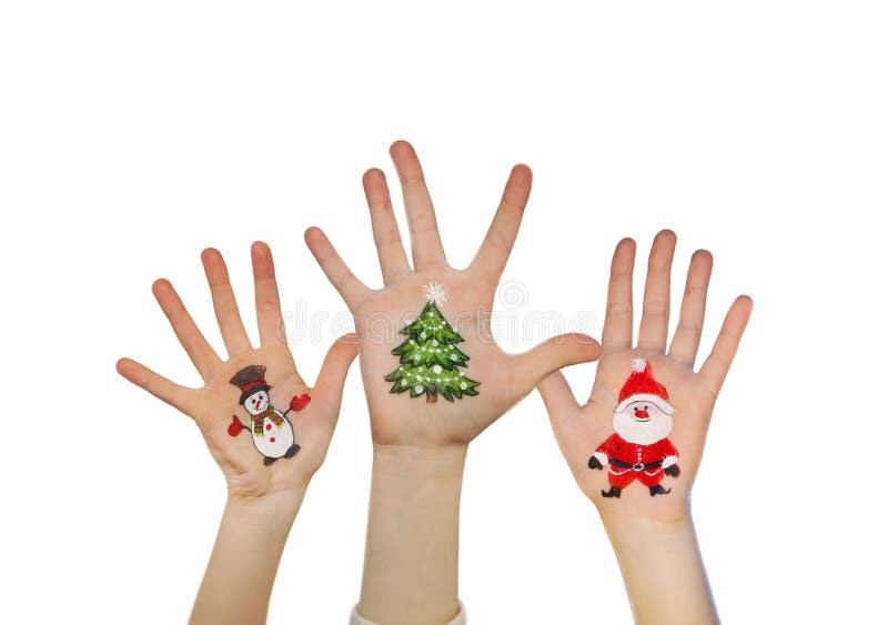 Las manos de los niños que aumentan para arriba con símbolos pintados de la Navidad: Santa Claus, árbol de navidad, hombre de la imagenes de archivo