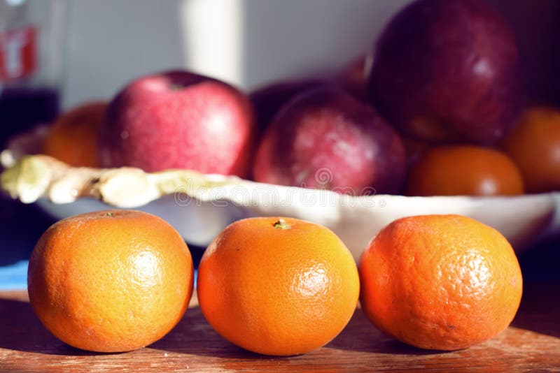 Las naranjas de la mandarina se alinearon en cocina con la cesta de fruta en la parte posterior imágenes de archivo libres de regalías Las naranjas de la mandarina se alinearon en cocina con la cesta de fruta en la parte posterior imágenes de archivo libres de regalías