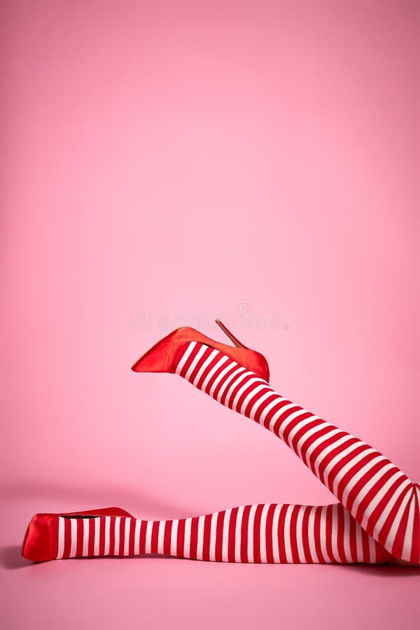 santa woman`s legs on a light pink background. santa woman`s legs on a light pink background