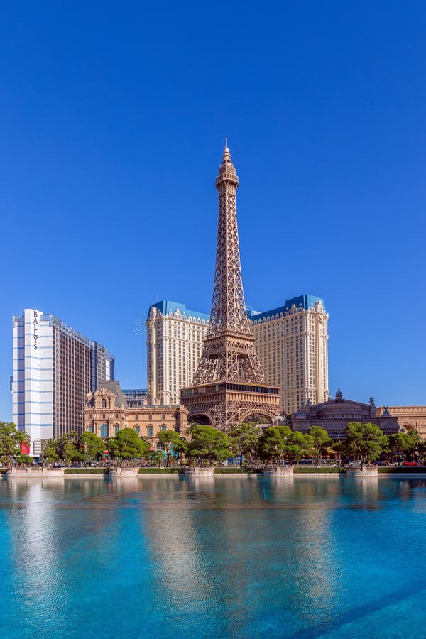 View across lake to replica Eiffel Tower at the Paris Hotel and Casino,  Bellagio fountains in