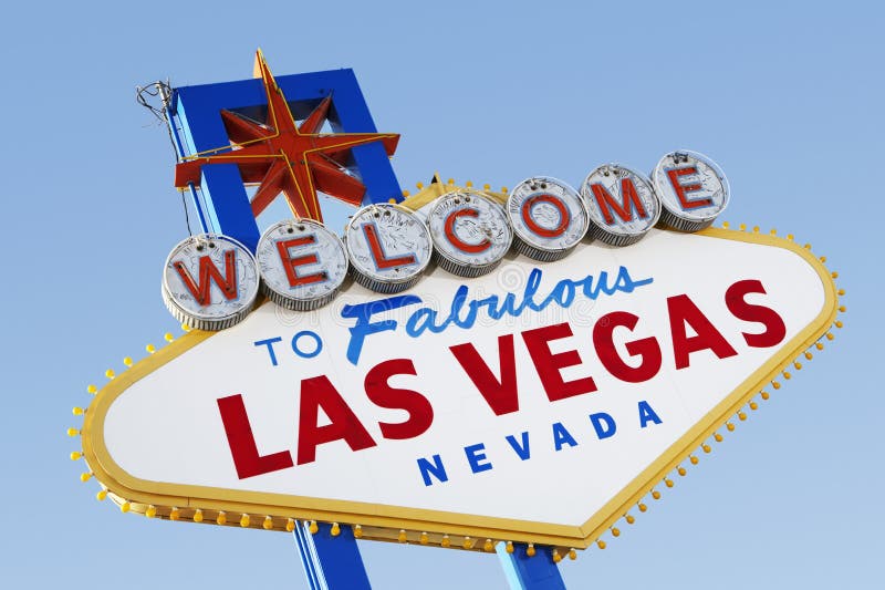 To Las Vegas Sign with Playing Card Suits in Grass Stock Photo