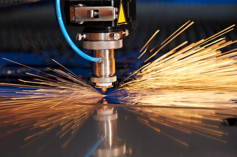 Laser cutting of metal sheet with sparks stock photography