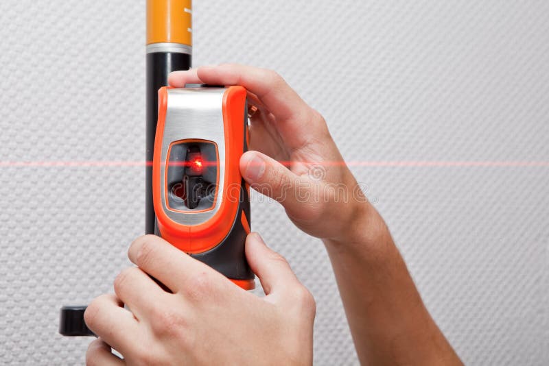 Man hands measuring with laser level gage