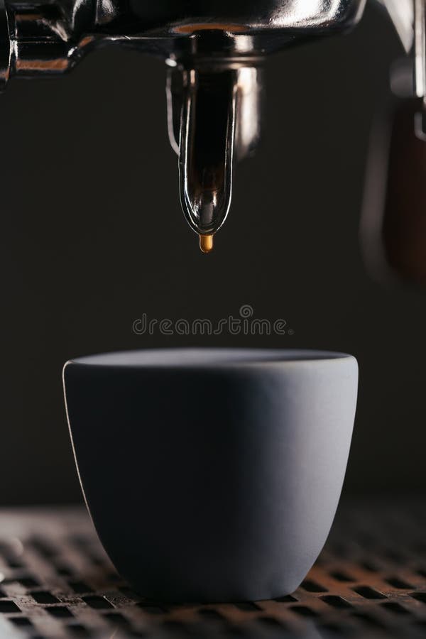 coffee extraction, drops, hot beverage, espresso dripping into cups,  professional coffee machine Stock Photo by LightFieldStudios