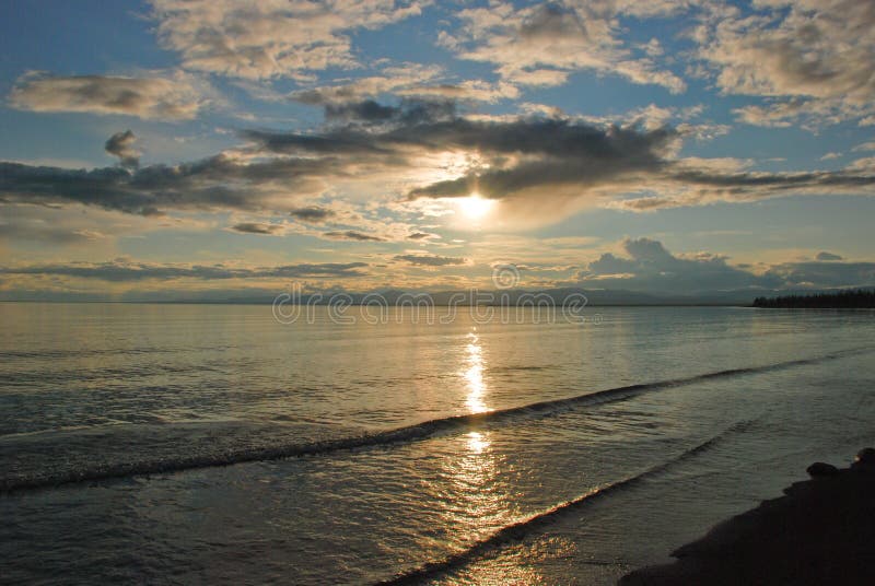 Setting sun is reflected in the water of the lake Lama.