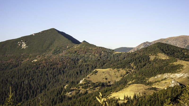 Last rays touch the high mountains in autumn