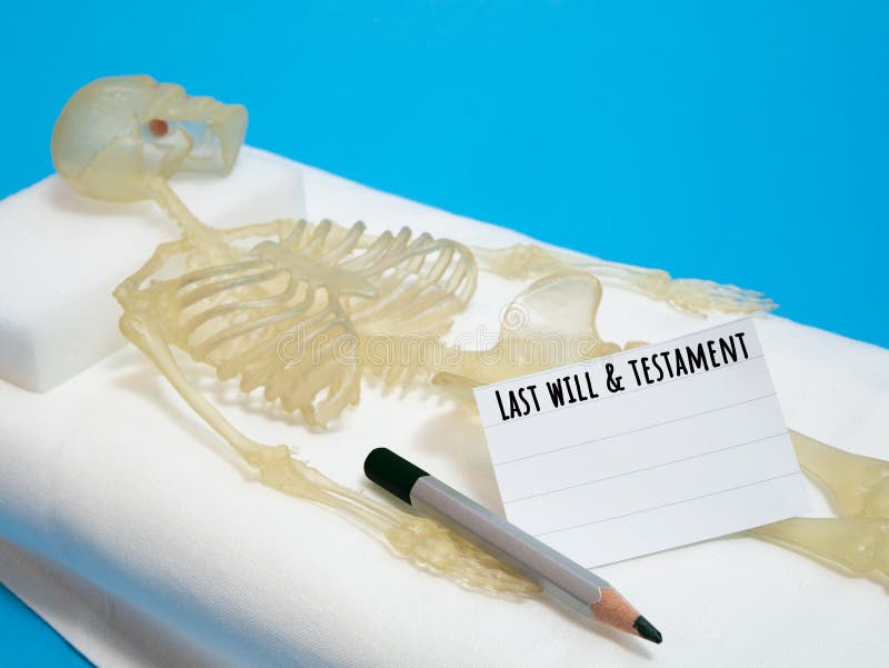 Last will and testament concept with human skeleton. Laying on deathbed with pencil and piece of paper royalty free stock photos