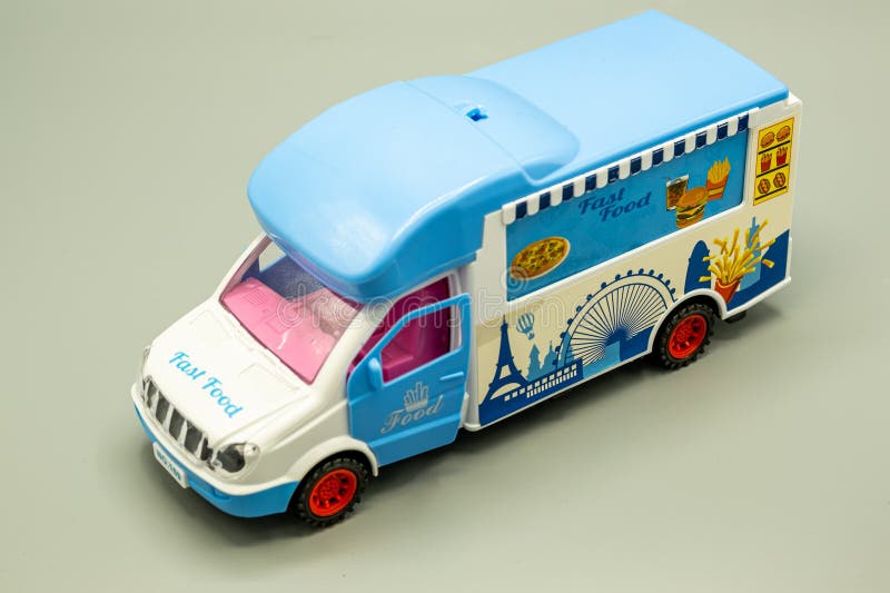 fast food truck with both side opening. die-cast and plastic truck with back and front opening, for children to play catering games. truck with blue white and pink colors.on gray back ground. fast food truck with both side opening. die-cast and plastic truck with back and front opening, for children to play catering games. truck with blue white and pink colors.on gray back ground.
