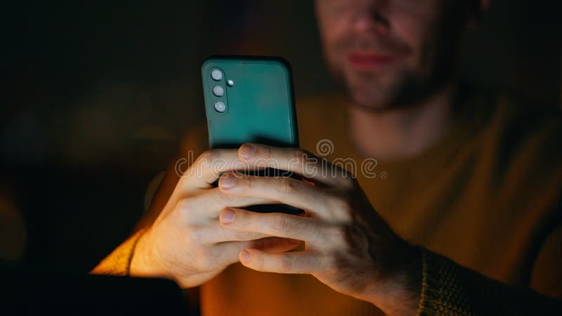 Late worker messaging cellphone in dark office closeup. Hands holding phone stock video footage