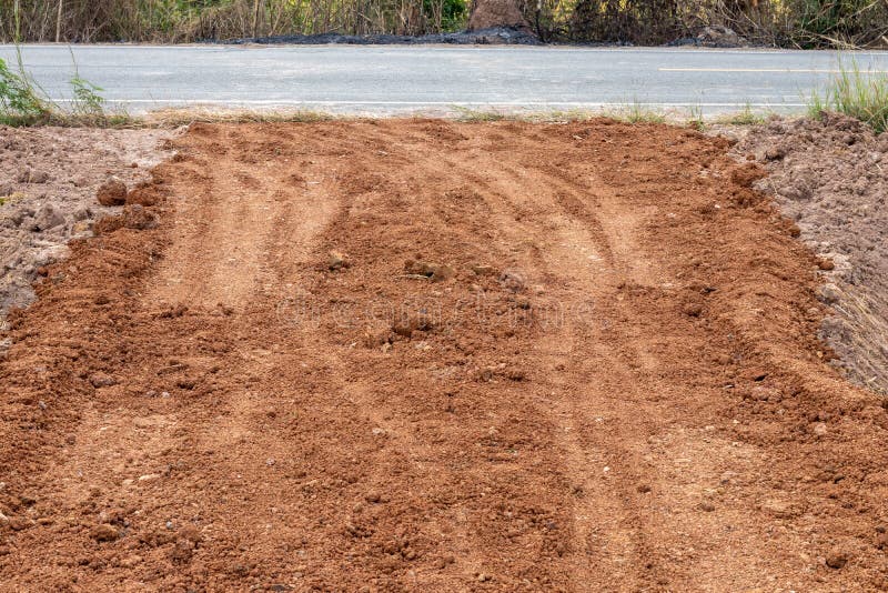 Laterite soil filling the ground near the paved road