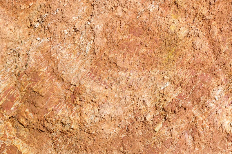 Close up red color lateritic soil cross section. Close up red color lateritic soil cross section