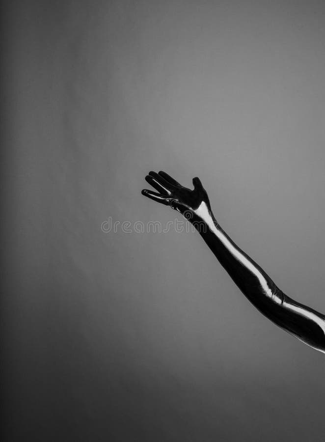 Latex gloves bondage concept with single arm on the grey background