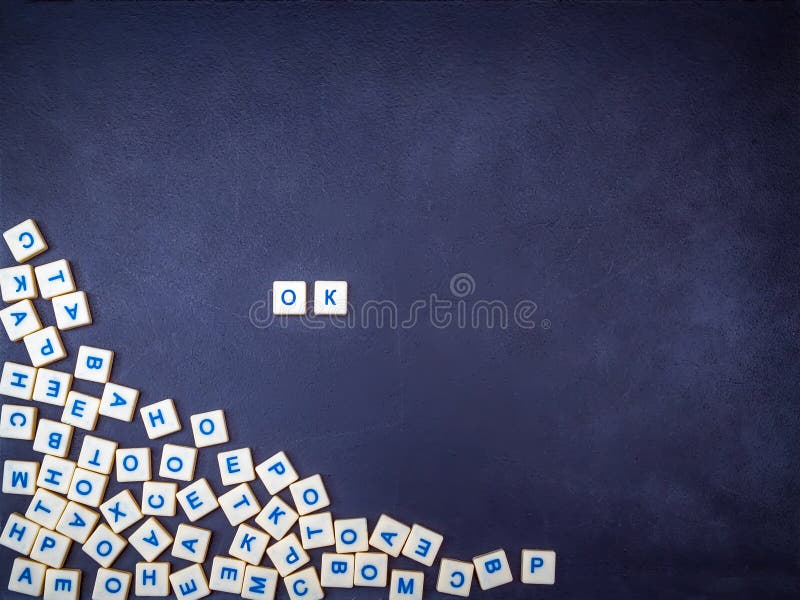 Latin alphabet letters on a dark slate board. Lettering OK. The concept of development knowledge and education. Top view stock photo