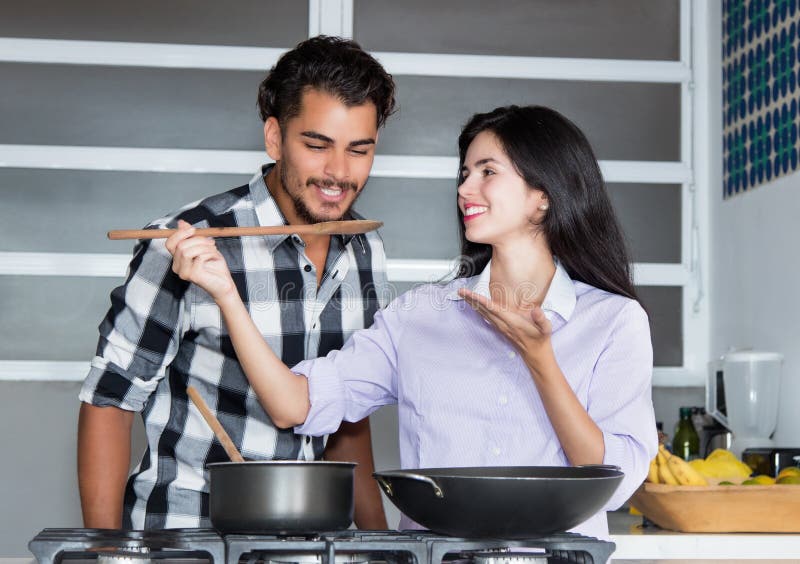Latin american love couple cooking at kitchen royalty free stock images Latin american love couple cooking at kitchen royalty free stock images