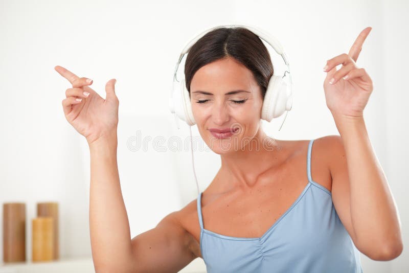 Latin female dancing while listening to music