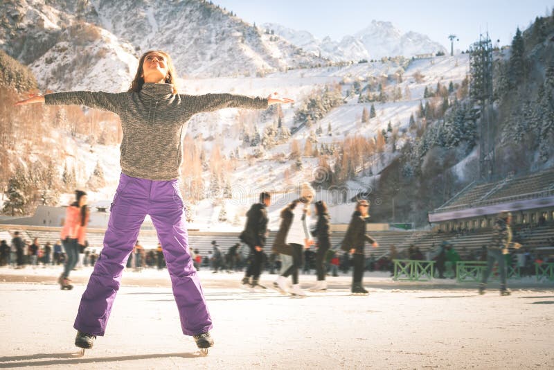 Latin girl ice skating outdoor at rink. Healthy lifestyle