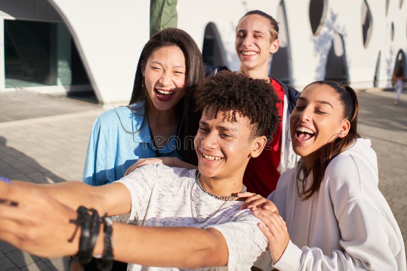 Latin Guy Taking A Selfie With A Multiracial Group Of People Happy 