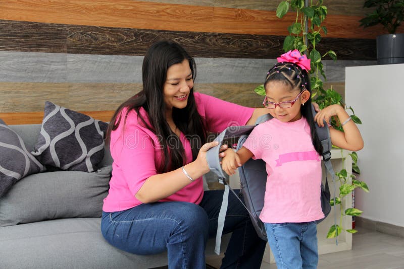 Latin Mom With Her 4 Year Old Daughter Who Wears Glasses Prepare To Go