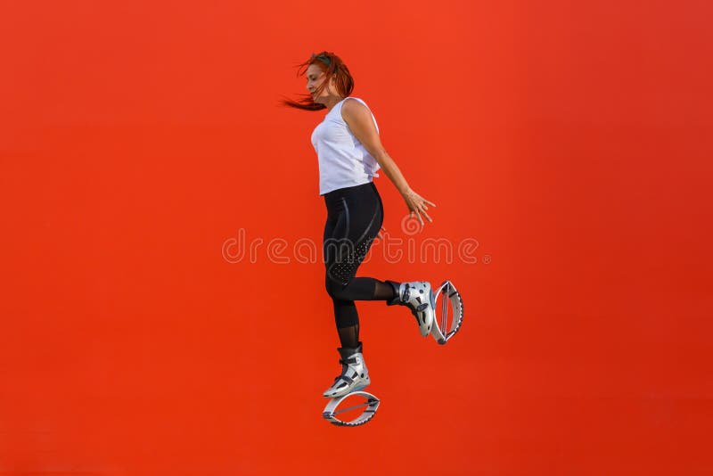 Female Trainer Doing Exercises Jumping In The Kangoo Jumps Boots Stock  Photo - Download Image Now - iStock