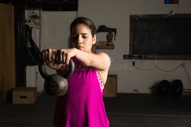 Latin woman lifting a kettlebell royalty free stock image Latin woman lifting a kettlebell royalty free stock image