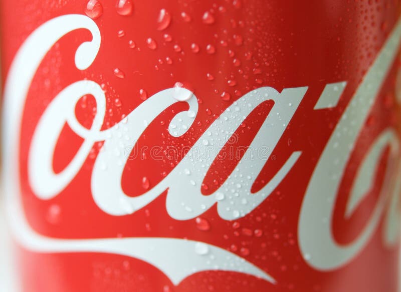 Latte Classiche Della Coca-cola Nelle Gocce Di Acqua Fotografia