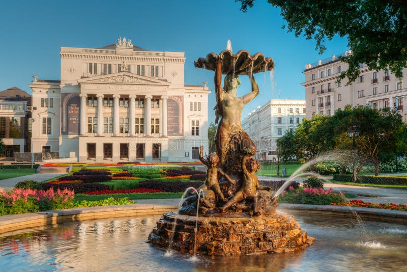 Riga, Latvia. Fountain Nymph In Water Splashes In Aspazijas Boulevard Near National Opera House. Riga, Latvia. Fountain Nymph In Water Splashes In Aspazijas Boulevard Near National Opera House.