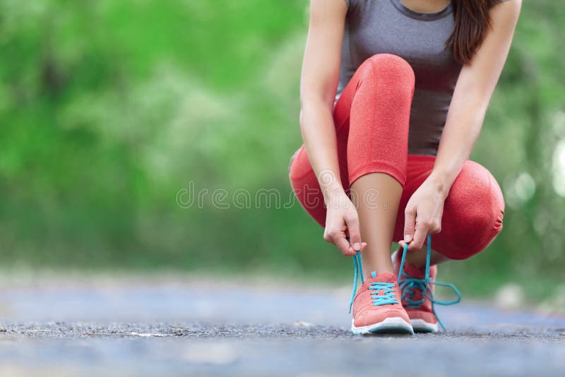 Laufschuhe - Nahaufnahme der Frau Schnürsenkel binden stockfotos