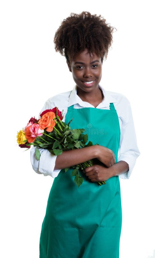 Laughing african american female florist with curly hair and green apron royalty free stock photography Laughing african american female florist with curly hair and green apron royalty free stock photography
