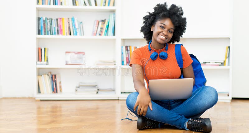 Laughing african american female student learning online at computer with students indoors at home. Computer editing stock images, royalty-free photos and pictures