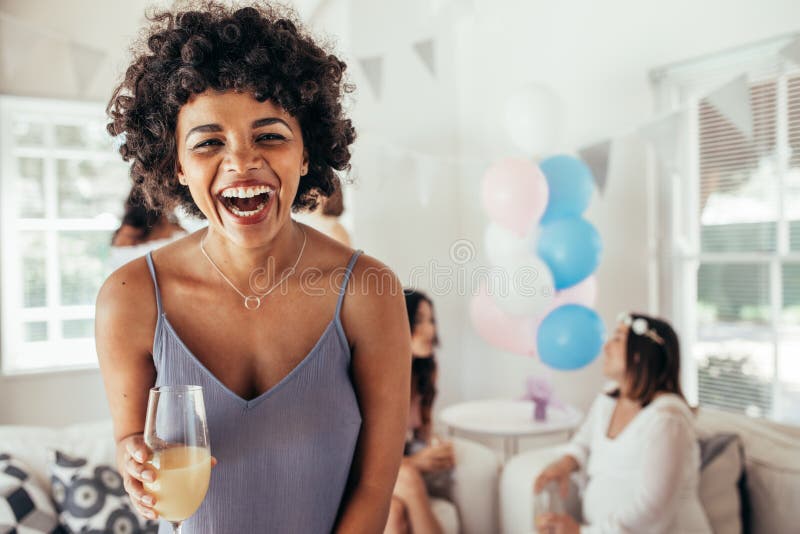 Laughing african woman at friend`s baby shower