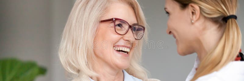 Horizontal photo aged young women laughing looking at each other royalty free stock image Horizontal photo aged young women laughing looking at each other royalty free stock image