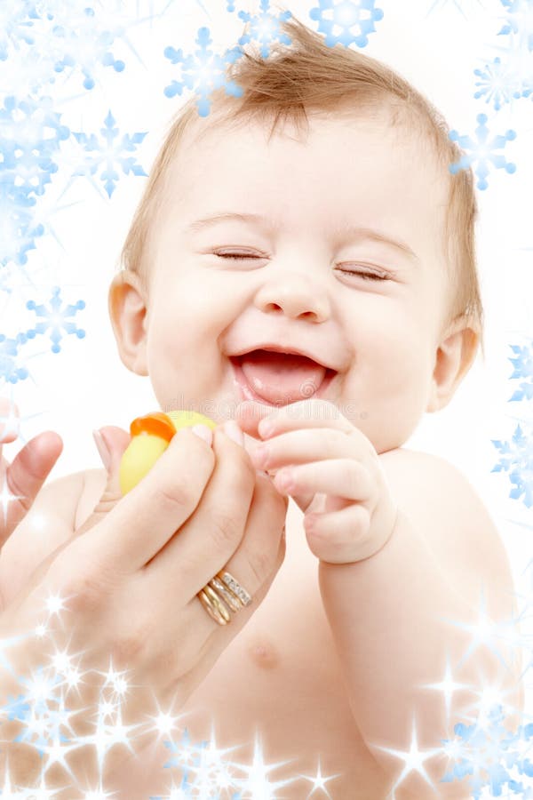 Laughing baby boy in mother hands with rubber duck royalty free stock image Laughing baby boy in mother hands with rubber duck royalty free stock image