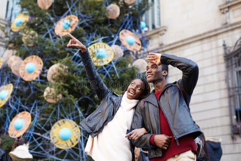 Laughing couple on christmas vacation walking in the city