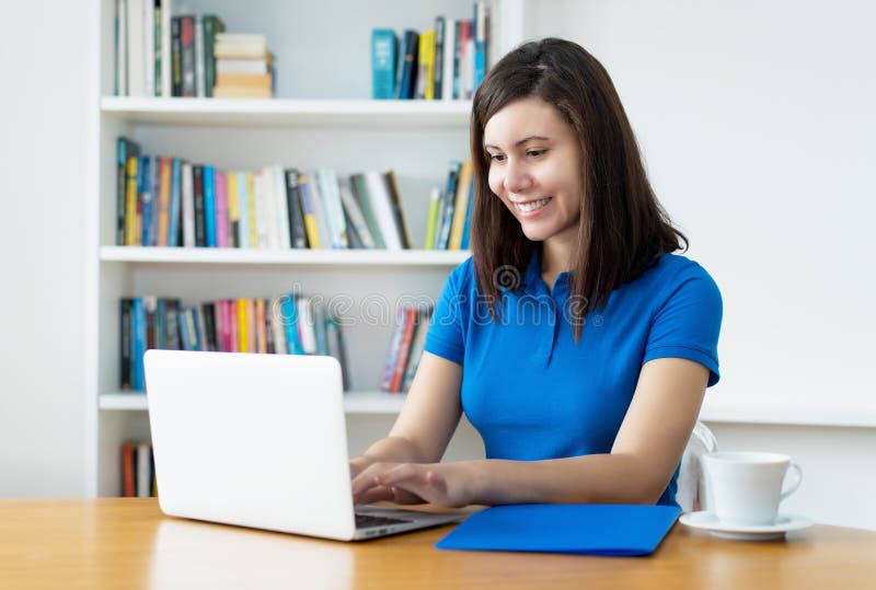Laughing female programmer working online at computer royalty free stock photos