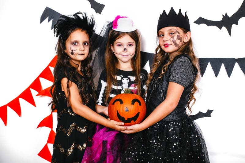 Four Laughing Children Wearing Costumes Playing Funny Halloween Games ...
