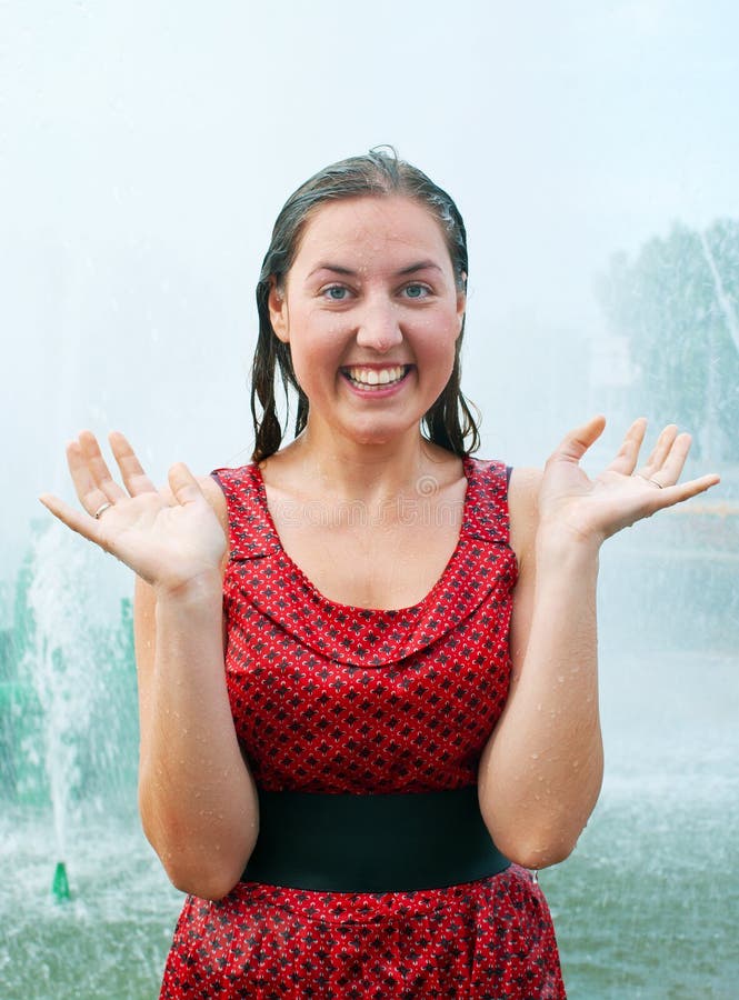 Laughing girl in wet clothes