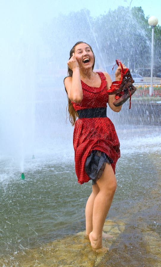 Laughing girl in wet clothes