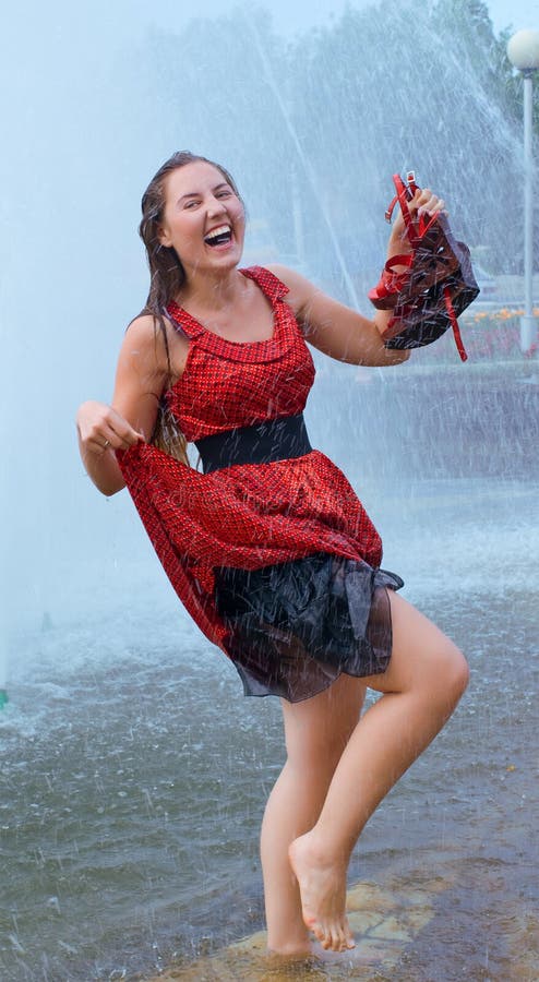 Laughing girl in wet clothes