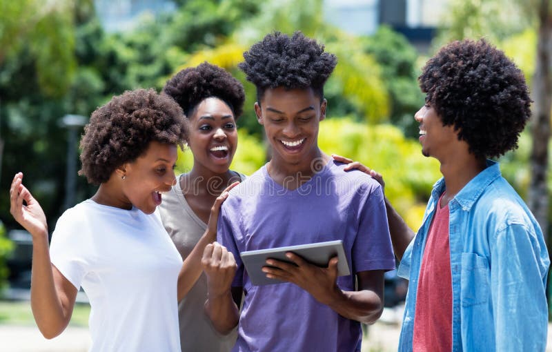 Laughing group of african american university students with digital tablet royalty free stock photography Laughing group of african american university students with digital tablet royalty free stock photography