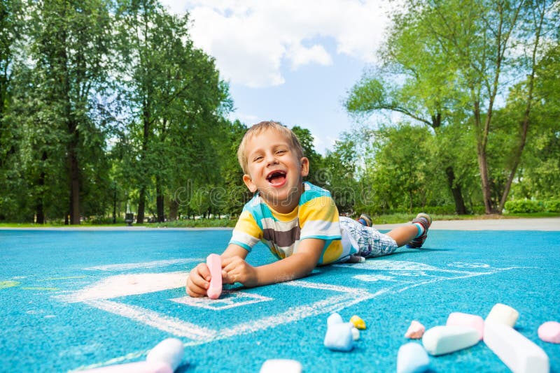 Laughing Boy Laying On The Autumn Leaves With Rake Stock Image - Image ...