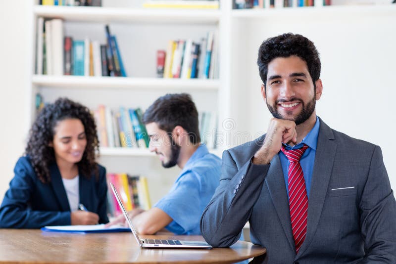 Laughing hispanic businessman with group of latin american business people stock photos.