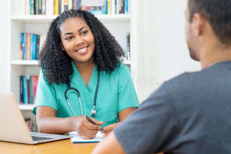 Laughing Latin American Female Nurse Or Young Doctor Listening To