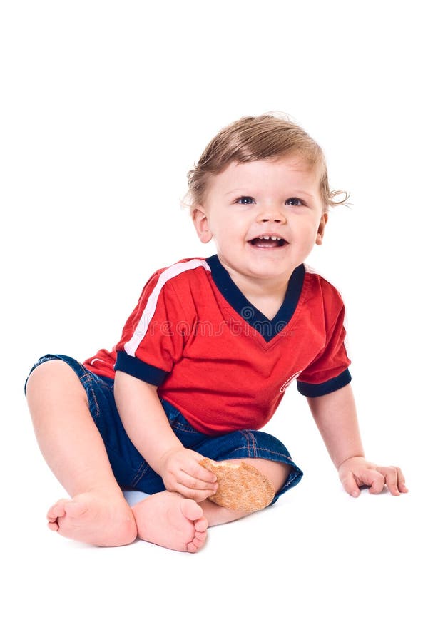 Laughing little boy with cookies in hand