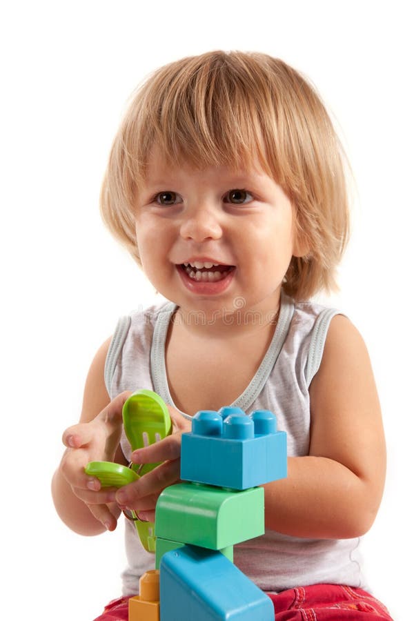Laughing little boy playing with blocks royalty free stock image