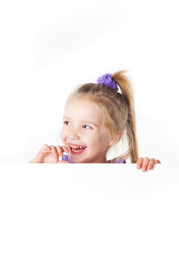 Laughing little girl looking over empty board