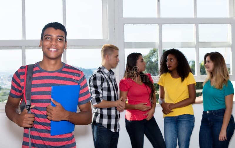 Laughing student from India with international students at university