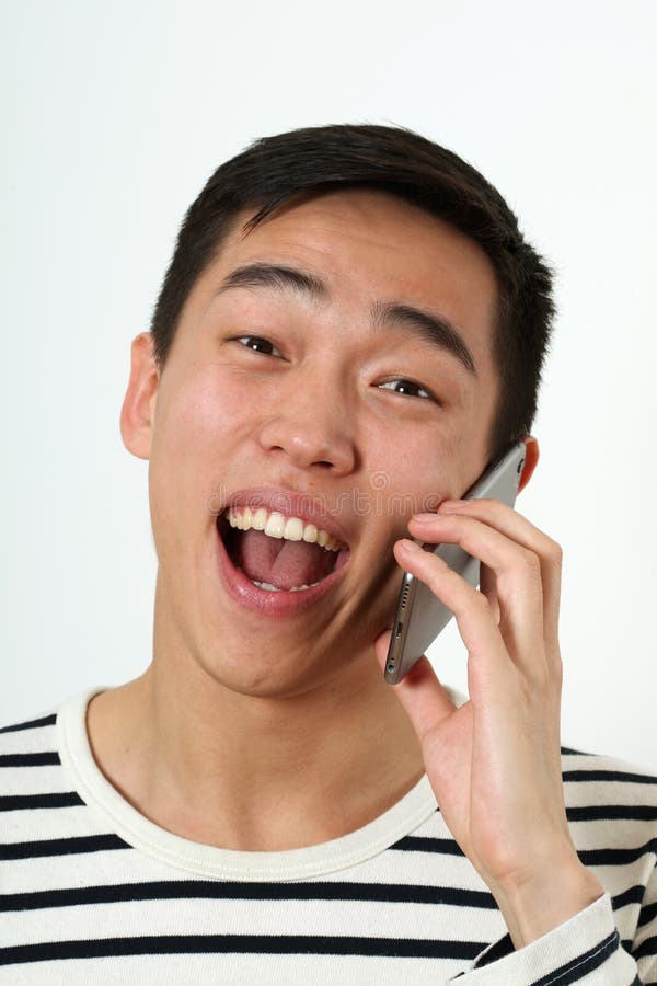 Laughing young Asian man using a smartphone